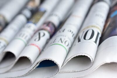 Folded newspapers stacked in a row
